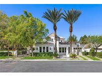 Charming single-story home boasts manicured landscaping, a symmetrical facade and a private gated entryway at 1309 Reisling Ct, Las Vegas, NV 89144