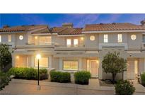 Charming townhome featuring a well-maintained exterior with lush landscaping and inviting curb appeal at 2219 Rugged Mesa Dr, Laughlin, NV 89029