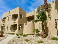 Attractive condo exterior with balconies, mature landscaping, and tan stucco finish at 2232 Aspen Mirror Dr # 203, Laughlin, NV 89029