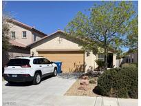 Charming single-Gathering home with a two-car garage, desert landscaping, and a private driveway at 3104 Scalise Ct, Las Vegas, NV 89141