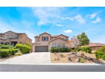 Stunning two-story home boasting a desert landscape, three windows, and an attached two-car garage at 33 Stonemark Dr, Henderson, NV 89052