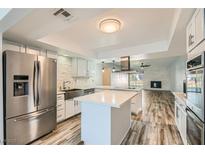 Bright kitchen features stainless steel appliances, island, and opens to an airy living space at 4347 S Mojave Rd, Las Vegas, NV 89121