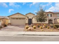 Charming single-story home featuring a desert landscape, brick driveway, and neutral stucco exterior at 7115 Calvert Cliffs St, North Las Vegas, NV 89084