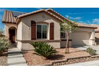 Charming single-story home features desert landscaping, tiled roof, and solar panels for energy efficiency at 7386 Campbell Ranch Ave, Las Vegas, NV 89179