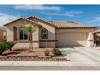 Charming home with a well-manicured front yard, brown shutters, and a two-car garage at 7386 Campbell Ranch Ave, Las Vegas, NV 89179