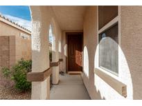 Inviting front entrance with decorative pillars and a classic wood door at 7386 Campbell Ranch Ave, Las Vegas, NV 89179
