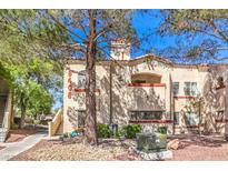 Charming two-story stucco building with red tile roof and desert landscaping at 8408 Running Deer Ave # 201, Las Vegas, NV 89145