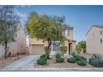 Two-story home with desert landscaping, covered front porch, and a two-car garage at 9089 Secret Valley St, Las Vegas, NV 89139