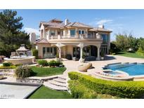 Stunning exterior features include a private pool, outdoor kitchen, and pristine landscaping at 9533 Orient Express Ct, Las Vegas, NV 89145