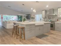 Charming kitchen featuring a large island with seating, stainless steel appliances, and a bright, open layout at 956 Puerta Del Sol Dr, Las Vegas, NV 89138