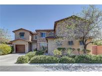 Stunning two-story home with a combination of stone and stucco, plus a well-manicured yard at 9992 Sky Parlor Rd, Las Vegas, NV 89178