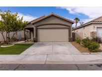 Charming single-story home with desert landscaping, two-car garage, and covered front porch at 1100 Warm Canyon Way, Las Vegas, NV 89123