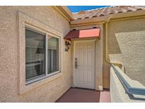 Inviting front entrance with a window and red awning providing shade to the door at 220 E Flamingo Rd # 402, Las Vegas, NV 89169