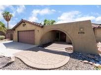 Charming home featuring a unique architectural design, desert landscaping, and an attached two-car garage at 5312 Manuel Dr, Las Vegas, NV 89149