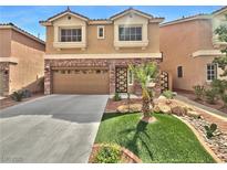 Charming two-story home features a well-maintained lawn, complemented by a two car garage and a stone facade at 6053 Lambert Bridge Ave, Las Vegas, NV 89139
