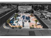Expansive aerial view showcases the property's layout, pool, solar panels, and convenient access to nearby freeway at 6882 Palmyra Ave, Las Vegas, NV 89146