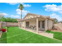 Outdoor living with covered patio, lush green lawn, and plenty of space to relax or entertain at 8009 Tailwind Ave, Las Vegas, NV 89131