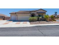Charming single-story home with a three-car garage, desert landscaping, and a tile roof at 8249 Jo Marcy Dr, Las Vegas, NV 89131