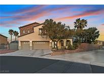 Inviting home with a three-car garage, stone accents, lush landscaping, and a serene, suburban atmosphere at 9008 Sawhill Pond St, Las Vegas, NV 89131
