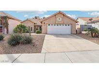 Charming single-story home features a desert-landscaped front yard and an attached two-car garage at 256 Helmsdale Dr, Henderson, NV 89014