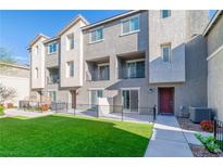 Modern townhouse with a well-maintained lawn and inviting outdoor spaces at 2843 Kona Blue Ln # 4, Las Vegas, NV 89183