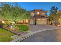 Beautiful two-story home boasts a well-manicured lawn, mature landscaping, and a paver driveway leading to a two-car garage at 4651 Munich Ct, Las Vegas, NV 89147