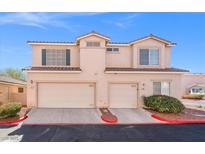 Charming two-story home featuring a tile roof, desert landscaping, and two-car garage at 51 Belle Point Ave, Las Vegas, NV 89123