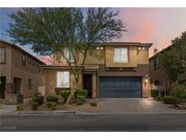 Charming two-story home with a well-manicured front yard, desert landscaping and a two-car garage at 5317 Golden Melody Ln, North Las Vegas, NV 89081