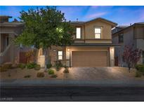 Charming two-story home with a well-manicured lawn, mature tree, and two car garage at 5594 Trilling Bird Dr, Las Vegas, NV 89135