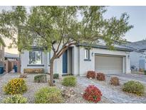 Charming single-story home with desert landscaping, a brick driveway, and a welcoming front entrance at 6445 N Alpine Ridge Way, Las Vegas, NV 89149