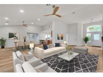 Bright living room with modern furnishings, stylish rug, and wood-look floors, perfect for entertaining at 8537 Glenmount Dr, Las Vegas, NV 89134