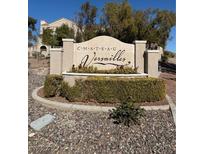 Chateau Versailles neighborhood entrance sign surrounded by landscaping and decorative rocks at 10550 W Alexander Rd # 2183, Las Vegas, NV 89129