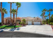 Charming single-story home with a well-manicured lawn, desert landscaping and a three-car garage at 11037 Clarion Ln, Las Vegas, NV 89134