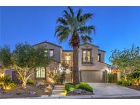 Elegant two-story home featuring a lush landscaped yard with mature trees and a private balcony at 11573 Glowing Sunset Ln, Las Vegas, NV 89135