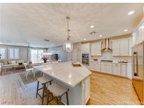 Modern kitchen featuring a large island with seating, stainless steel appliances, and an open floor plan at 2767 Flowing Breeze St, Henderson, NV 89044