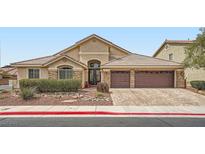 Charming single-story home with desert landscaping and a three-car garage with a paver driveway at 3728 Granada Gorge Ln, North Las Vegas, NV 89084