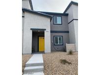 Contemporary home featuring a bright yellow front door and low maintenance landscaping at 532 Clearsable Ave, Henderson, NV 89044