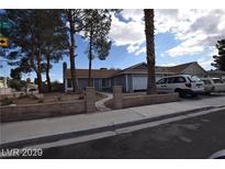 Charming single-story home with a well-manicured front yard and a two-car garage in a residential neighborhood at 5901 Oceanside Way, Las Vegas, NV 89108