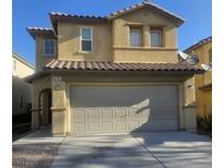 Two-story home featuring a large two car garage, stucco siding, and a tile roof at 6182 Blue Rapids Ct, Las Vegas, NV 89139