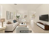 Bright living room features neutral furniture and a modern open-concept design at 6480 Chebec St, North Las Vegas, NV 89084