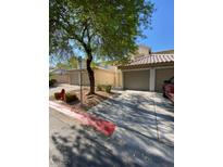 Charming townhouse featuring desert landscaping, mature shade trees and a private, attached garage at 7564 Durham Hall Ave # 201, Las Vegas, NV 89130