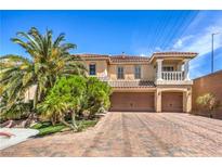 Charming two-story home with a three-car garage, tile roof, and landscaped front yard at 8454 Mondavi Hill Ct, Las Vegas, NV 89139