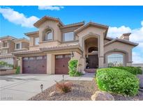 Stunning two-story home with three-car garage, desert landscaping and covered front entry at 8824 Prague Ct, Las Vegas, NV 89147