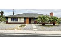 Charming single-story home featuring a unique window design and mature palm trees at 1801 Griffith Ave, Las Vegas, NV 89104
