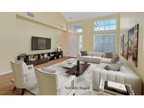 Bright living room featuring vaulted ceilings, updated furniture, and an abundance of natural light at 681 Peach Coral St, Las Vegas, NV 89183