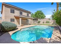 Backyard pool with clear blue water and a white fence in a private backyard setting at 681 Peach Coral St, Las Vegas, NV 89183
