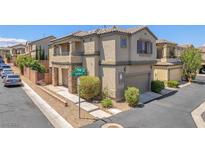 Two-story home with a covered front porch, desert landscaping, and an attached two-car garage at 7865 Solid Horn Ct, Las Vegas, NV 89149
