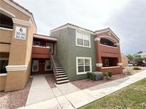 Condo building with multiple units, a stairway, and desert landscaping around the complex at 8101 W Flamingo Rd # 1044, Las Vegas, NV 89147
