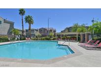 Sparkling community pool with lounge chairs and meticulously maintained landscaping in a gated community at 8919 Don Valley Ave, Las Vegas, NV 89148