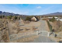 Spacious ranch home featuring gated entry, circular driveway, and mountain views at 170 Story Ave, Pahrump, NV 89060